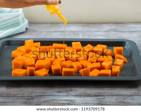 Similar – Image, Stock Photo Chopped pumpkin drizzled with oil for baking