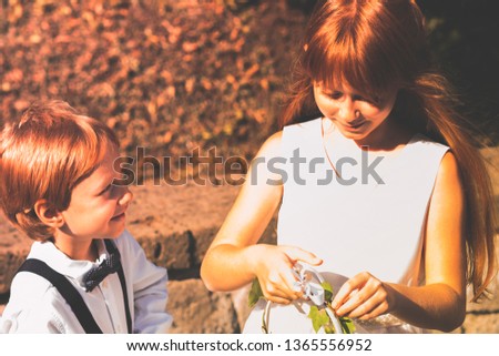 Similar – Foto Bild Ringträger bei Gartenhochzeit spielt mit Blumenstrauß