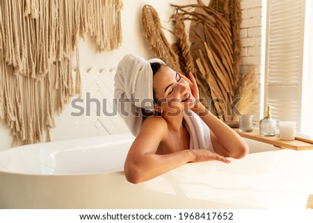 Image, Stock Photo Young woman in bathtub with balloons after party