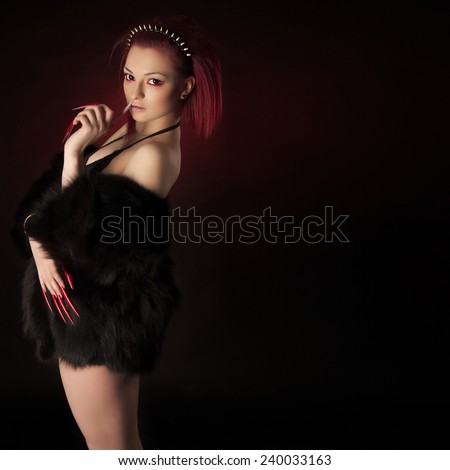 Beautiful sexy woman with red hair and long nails