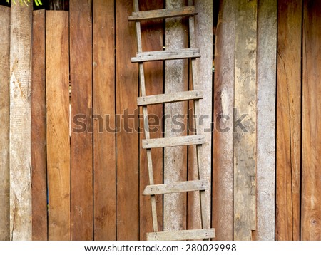 Hardwood handmade ladder with old wood wall background