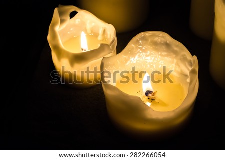 Two candle flames at night in the dark background