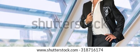 Disheveled man in black suit in office