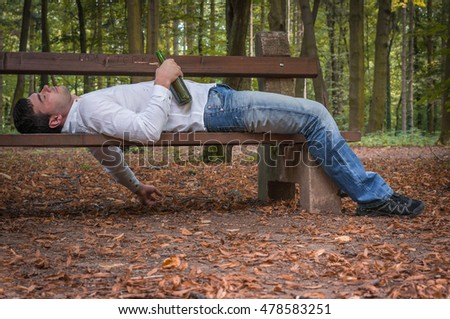 Depressed Drunk Man Asleep Outdoor On A Park Bench With Beer Bottles ...