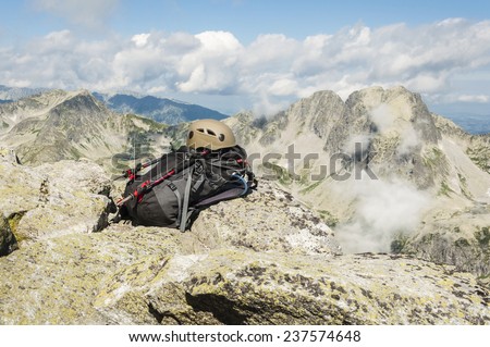 Helmet, backpack and trekking poles