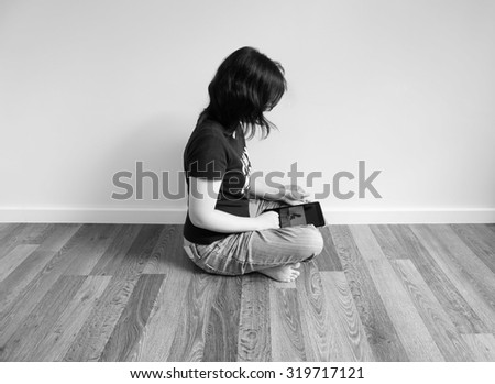 woman is playing tablet and watching picture in there, black and white image
