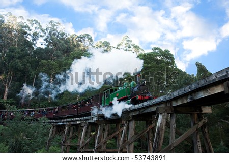 BELGRAVE - MAY 22: Historic Puffing Billy narrow guage steam train locomotive pulls carriages across trestle bridge in Sherbrooke Forest May 22, 2010 in Belgrave, Victoria, Australia.