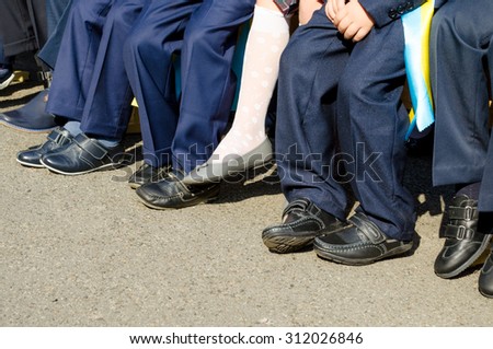 September 1 in Ukrainian school. Small kids legs.