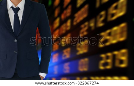businessman in suit on number board background