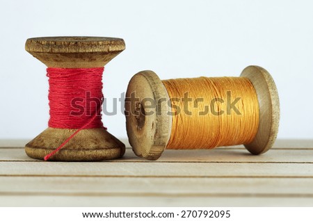 Old spool of thread closeup. Tailor\'s work table. textile or fine cloth making.