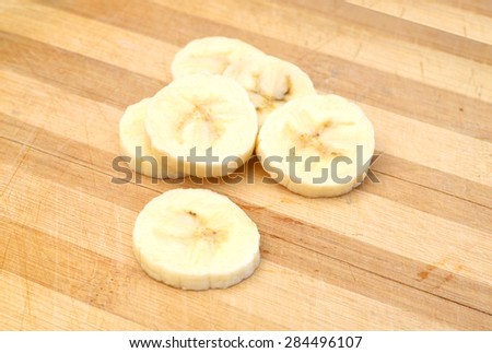Banana slices isolated on wooden board