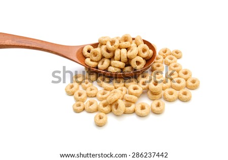 healthy cereal rings and wooden spoon on white