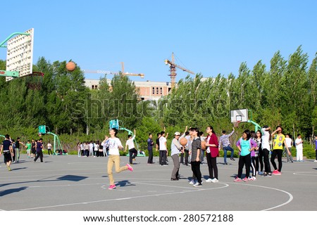 CHANGCHUN, JILIN, CHINA - MAY 21,2015 - Female students of a public university practice basketball in a sunny day on May 21, 2015