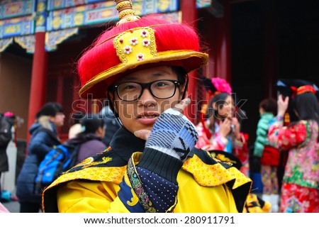 BEIJING, CHINA - FEBRUARY 1 - At the Forbidden City, a Chinese young boy wears traditional costumes while poses for a picture on February 1, 2014.