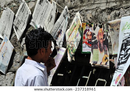 ABBOTTABAD, PAKISTAN - MAY 15: Pakistani man reading newspapers and daily life on May 15, 2011 in Abbottabad, Pakistan.