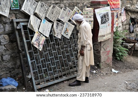 ABBOTTABAD, PAKISTAN - MAY 15: Pakistani man reading newspapers and daily life on May 15, 2011 in Abbottabad, Pakistan.