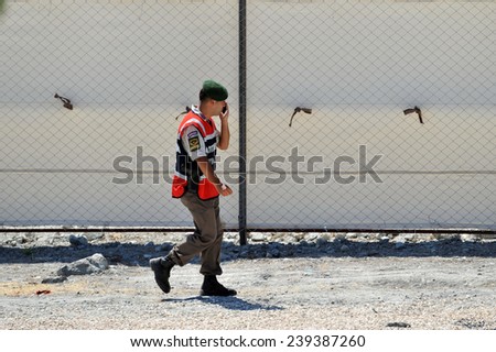 TURKISH-SYRIAN BORDER -JUNE 18, 2011: unidentified Turkish soldier guard in refugee camp in Turkey on June 18, 2011 on the Turkish - Syrian border.