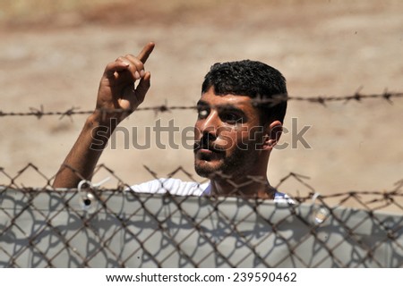 TURKISH-SYRIAN BORDER -JUNE 21, 2011: unidentified Syrian people in refugee camp in Turkey on June 21, 2011 on the Turkish - Syrian border.