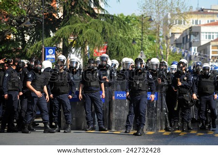 ISTANBUL - MAY 1: Many people can\'t take part in May Day march on May 1, 2009 in Istanbul. Police blocked all the ways to Taksim Square to prevent the activists from joining their mates. Policeman
