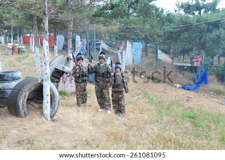 ISTANBUL, TURKEY - AUGUST  07:  Paintball extreme sport players team in protective camouflage uniform and mask with markers gun in summer field on August 07, 2012 in Istanbul, Turkey.