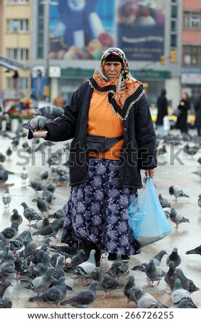ISTANBUL, TURKEY - MARCH  11: People who feed the pigeons Taksim Square on March  11, 2006 in Istanbul, Turkey.