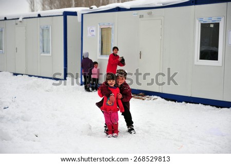 VAN, TURKEY - JAN 26: Earthquake victim children in the prefabricated house city.  at the earthquake of Van-Ercis on January  26, 2012 in Van, Turkey.