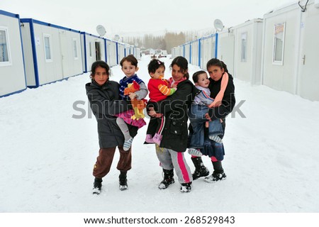 VAN, TURKEY - JAN 26: Earthquake victim children in the prefabricated house city.  at the earthquake of Van-Ercis on January  26, 2012 in Van, Turkey.