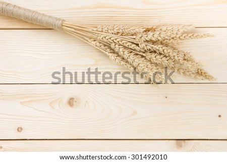 Wheat Ears on Wooden Table. Sheaf of Wheat over Wood Background. Harvest concept. Top view