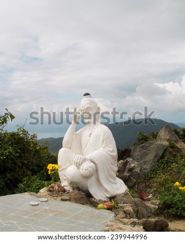White statue of eastern sage with chessboard on top of the hill near Danang, Vietnam