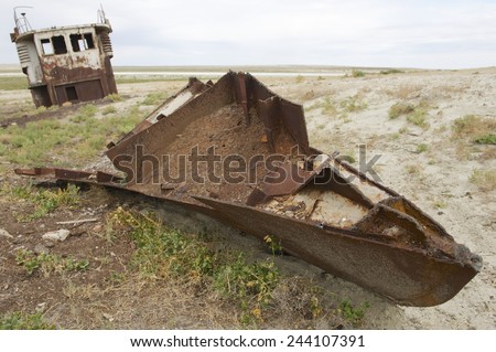 Remains of fishing boat at the sea bed of the Aral sea, Aralsk, Kazakhstan. Evaporation of one of four largest lakes in the world is considered one of the planet\'s worst environmental disasters.