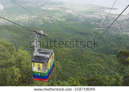 PURTO PLATA, DOMINICAN REPUBLIC - NOVEMBER 04, 2012: Unidentified tourists ride the cable car to the top of Pico Isabel de Torres. This aerial tramway is the only one in the Caribbean.