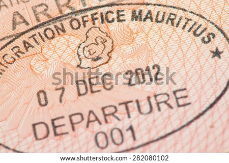 Passport page with Mauritius immigration control departure stamp with traditional Dodo bird depicted on it.