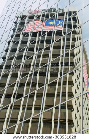 KUALA LUMPUR, MALAYSIA - AUGUST 29, 2009: Reflection of the HSBC bank building with Malaysian flag in modern building glass windows in Kuala Lumpur, Malaysia.