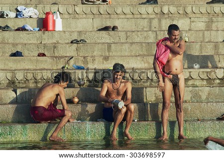 VARANASI, INDIA - MARCH 25, 2007: Unidentified hindu pilgrims bathe in Holy Ganges river at sunrise in Varanasi, India.