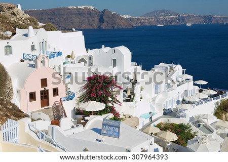 OIA, GREECE - AUGUST 02, 2012: View to hotels buildings with a sea view to volcanic caldera in Oia, Greece.