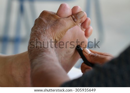 close up foot massage by old man\'s hands