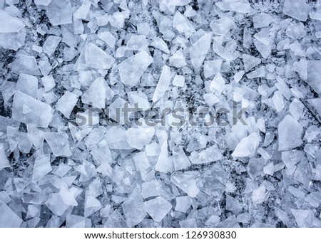 Background with shattered ice on lake in shades of blue