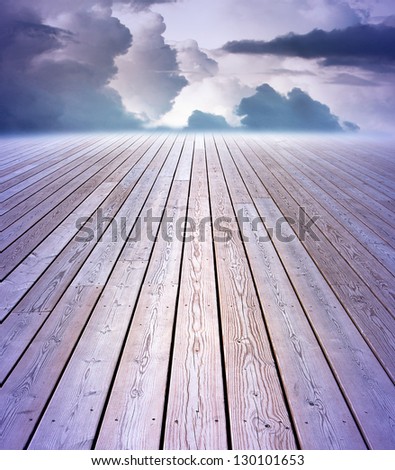 Wooden floor with purple sky in background