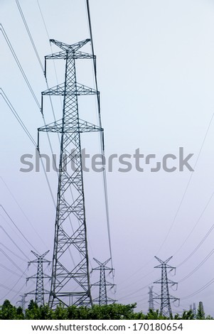 Power lines and pylons on purple sky