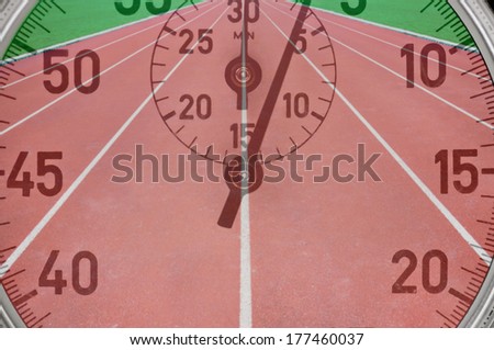 Red running tracks in sport stadium with vintage stop watch in foreground