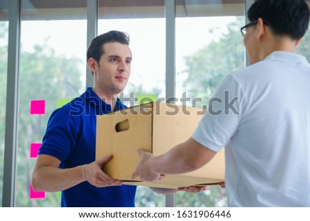 Delivery man giving parcel box to recipient,Man owner accepting of cardboard boxes package from post shipment,Online selling, e-commerce,Shipping concept. Foto stock © 