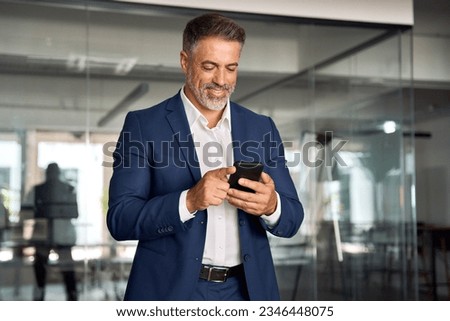 Similar – Image, Stock Photo Businessman browsing smartphone in city