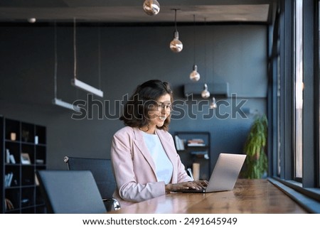 Similar – Image, Stock Photo A smiling girl in a Christmas hat sits on the sofa and communicates via video link with friends and shows them her gift. Girl congratulates friends and family on holidays