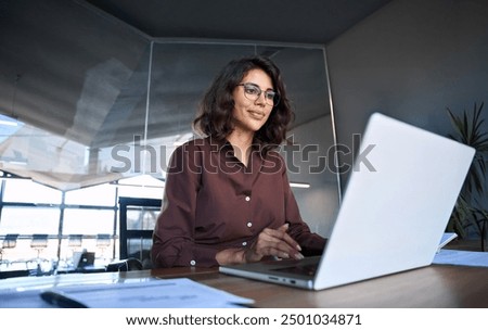 Similar – Image, Stock Photo Smiling woman using laptop in armchair