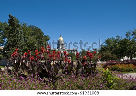 View of the gold-domed capitol building in Denver with flowers from Civic Center Park.
