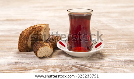 Turkish bagel & Turkish tea in traditional curved glass on wooden table
