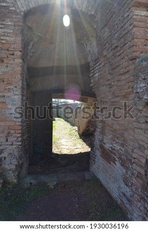 pasage inside ancient roman ruins of a brick house with sunlight from above in ostia antica rome italy Imagine de stoc © 