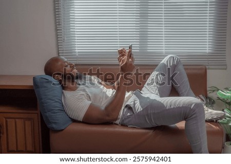 Similar – Image, Stock Photo Carefree black man lying on blanket with laptop in park