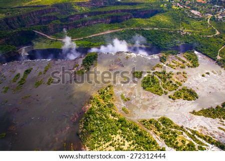 Aerial view of the Zambezi river right before Victoria Falls.  Clouds and mist rising up from the falls.