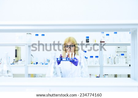 Young blonde woman scientist researcher in the laboratory of the University